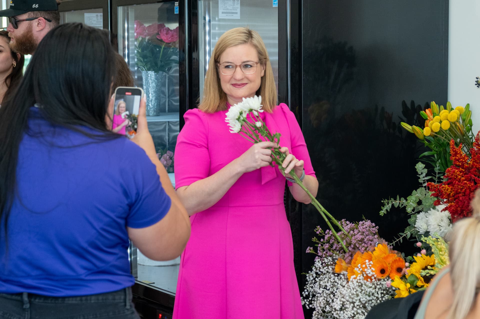 The Mayor of Phoenix gathering stems at the flower bar during the grand opening.