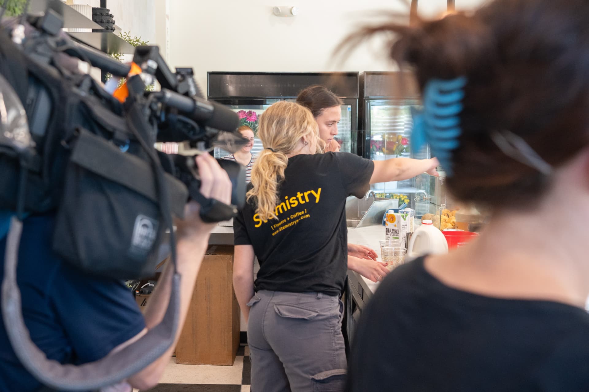 A news camera filming drink preparation at the Stemistry counter